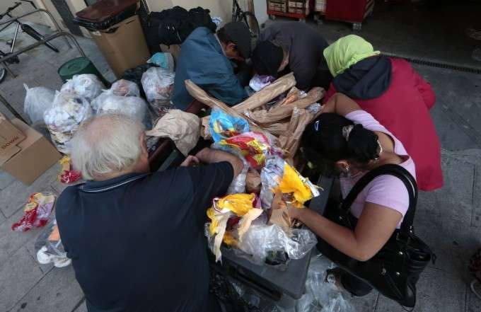 Евгений, 87-летний французский пенсионер, роется в мусорном баке в поисках пропитания. Ницца, Франция, 13 июня 2013 года. Фото: REUTERS/Eric Gaillard